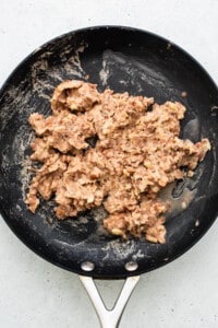 refried beans in pan.