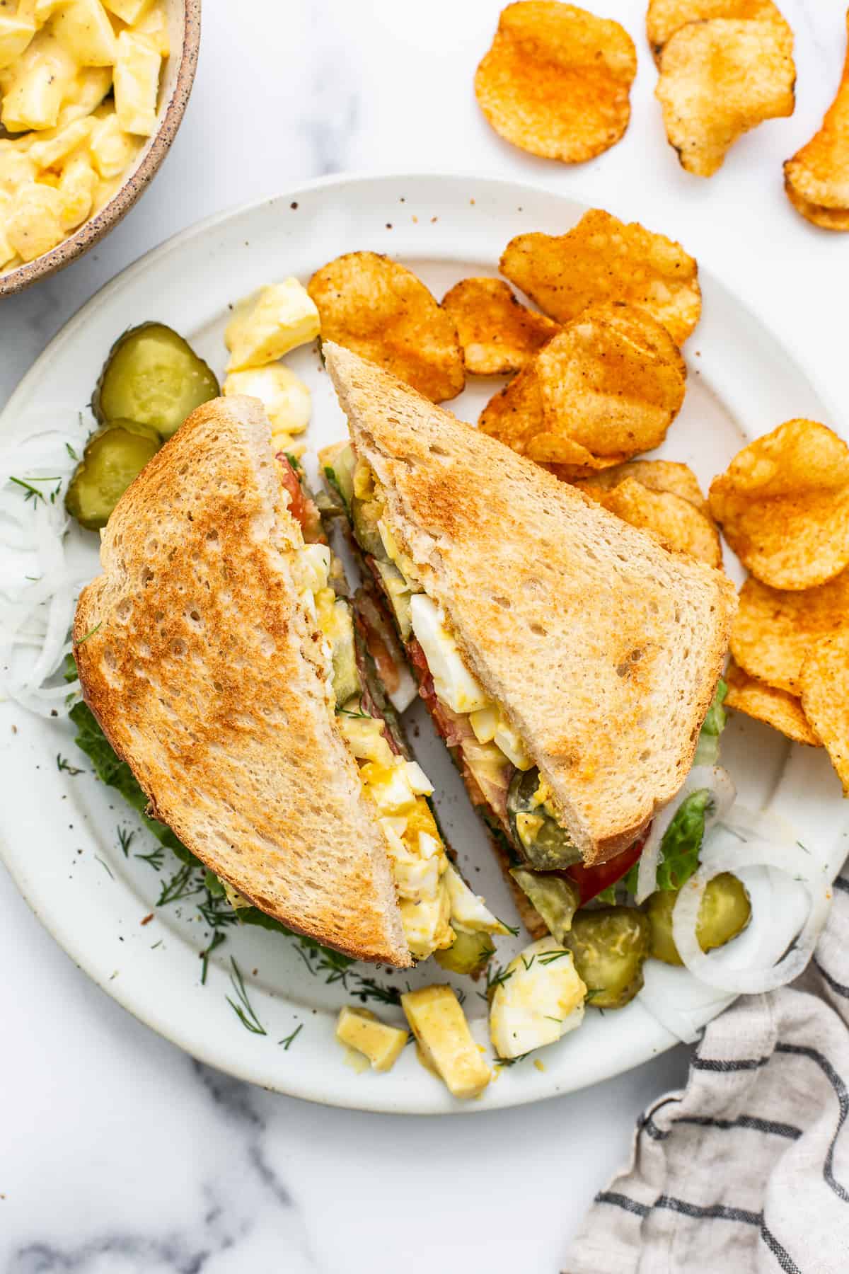 Egg salad sandwich on a plate.