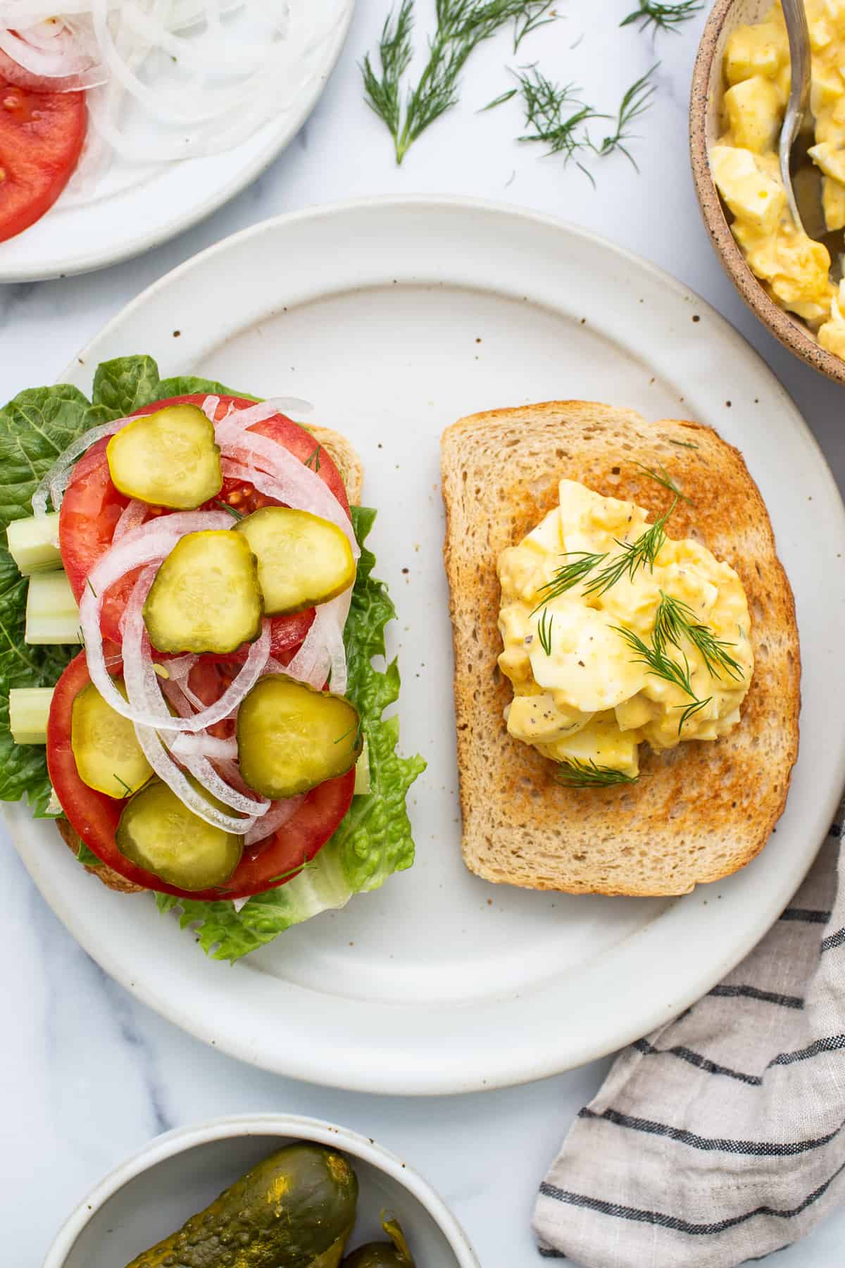 Egg salad sandwiches on a plate. 