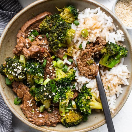 beef and broccoli with rice in bowl.