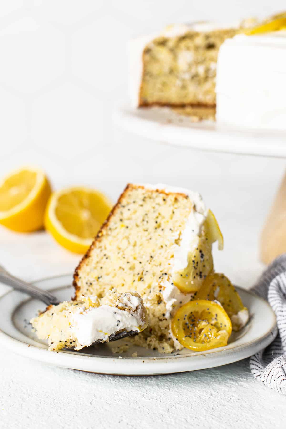 Slice of lemon poppy seed cake on a fork.