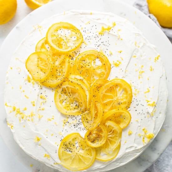 A cake topped with lemon slices and powdered sugar.