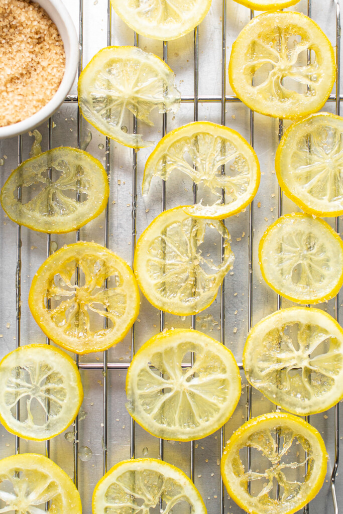 Candied lemon slices on a wire rack.