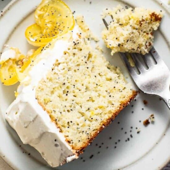 Slice of lemon poppy seed cake on a plate.