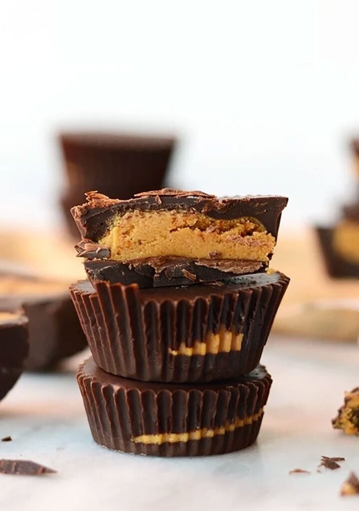 What's better than a peanut butter cup? A peanut butter cup amped with extra protein! Make these delicious protein peanut butter cups with just a few ingredients! stack of peanut butter cups.