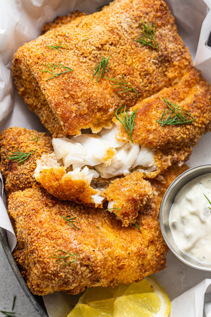 Flaky air fryer fish with tartar sauce.