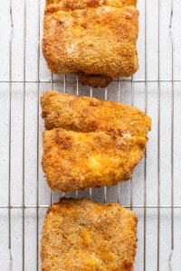 Air fryer fish on a cooling rack.