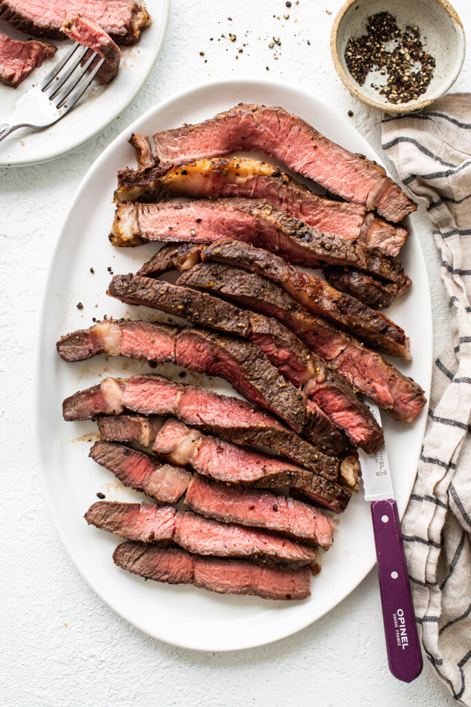 Sliced air fryer steak on a plate.