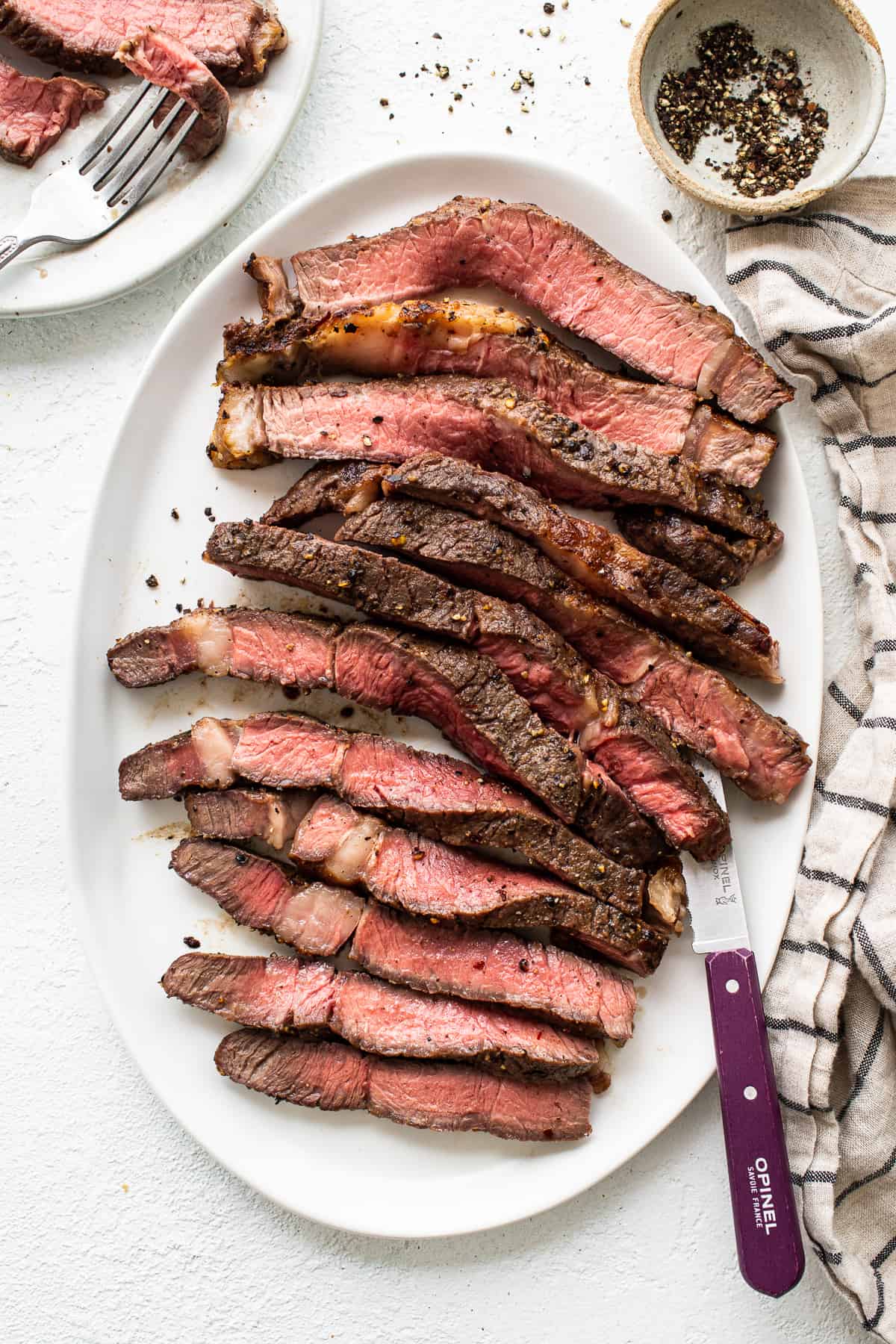 Sliced air fryer steak on a plate.