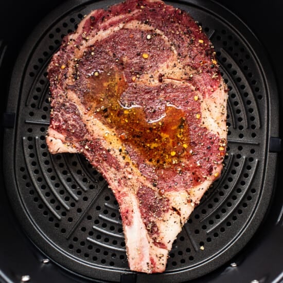 A steak is being cooked in an air fryer.