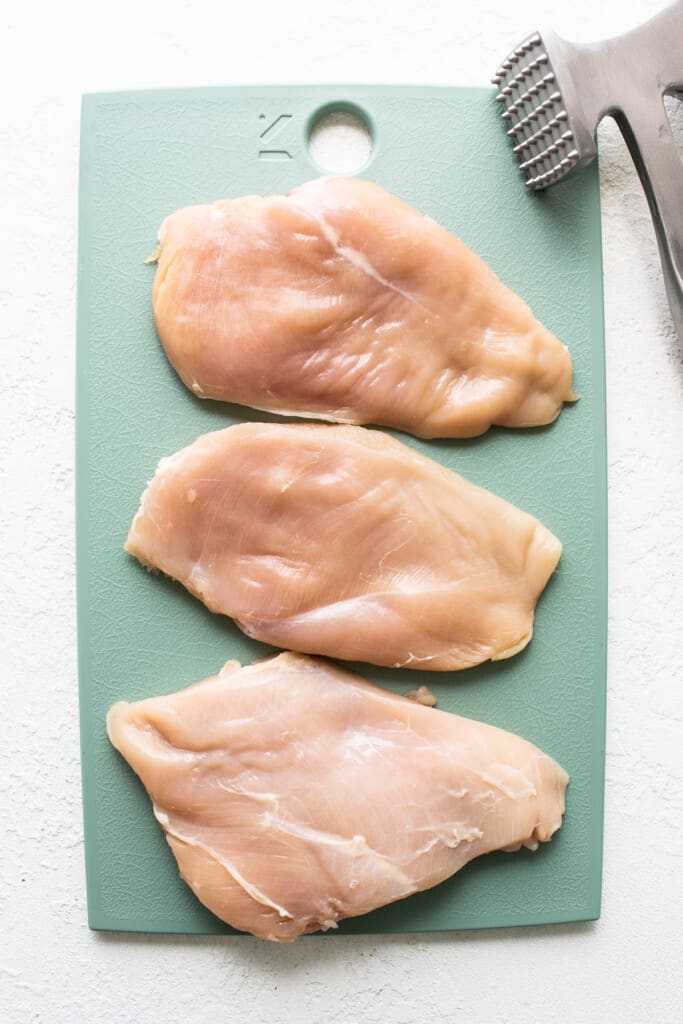 chicken breast on cutting board.