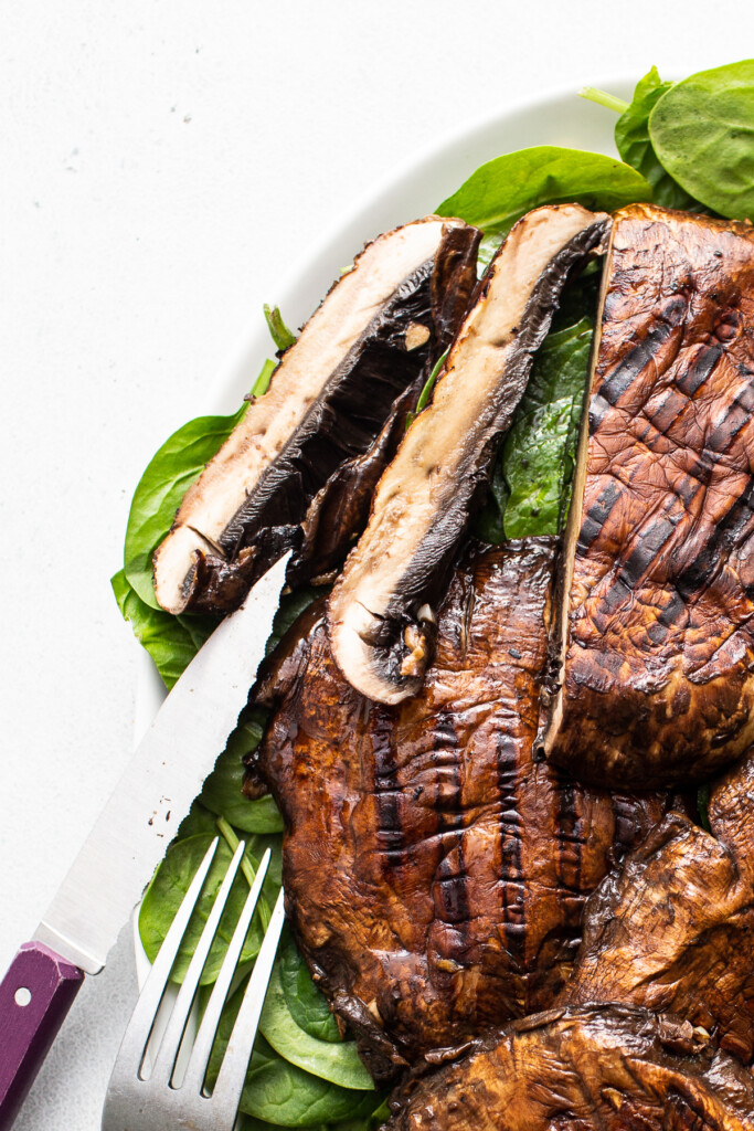 Sliced grilled portobello mushroom on a plate.