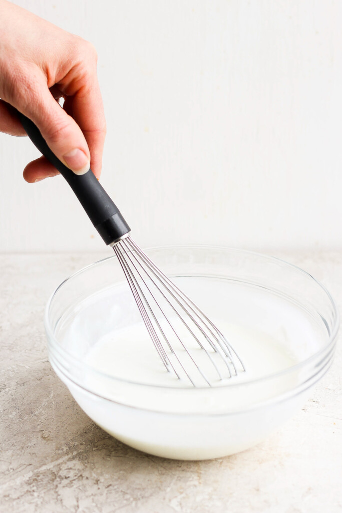 whisking dressing in bowl.