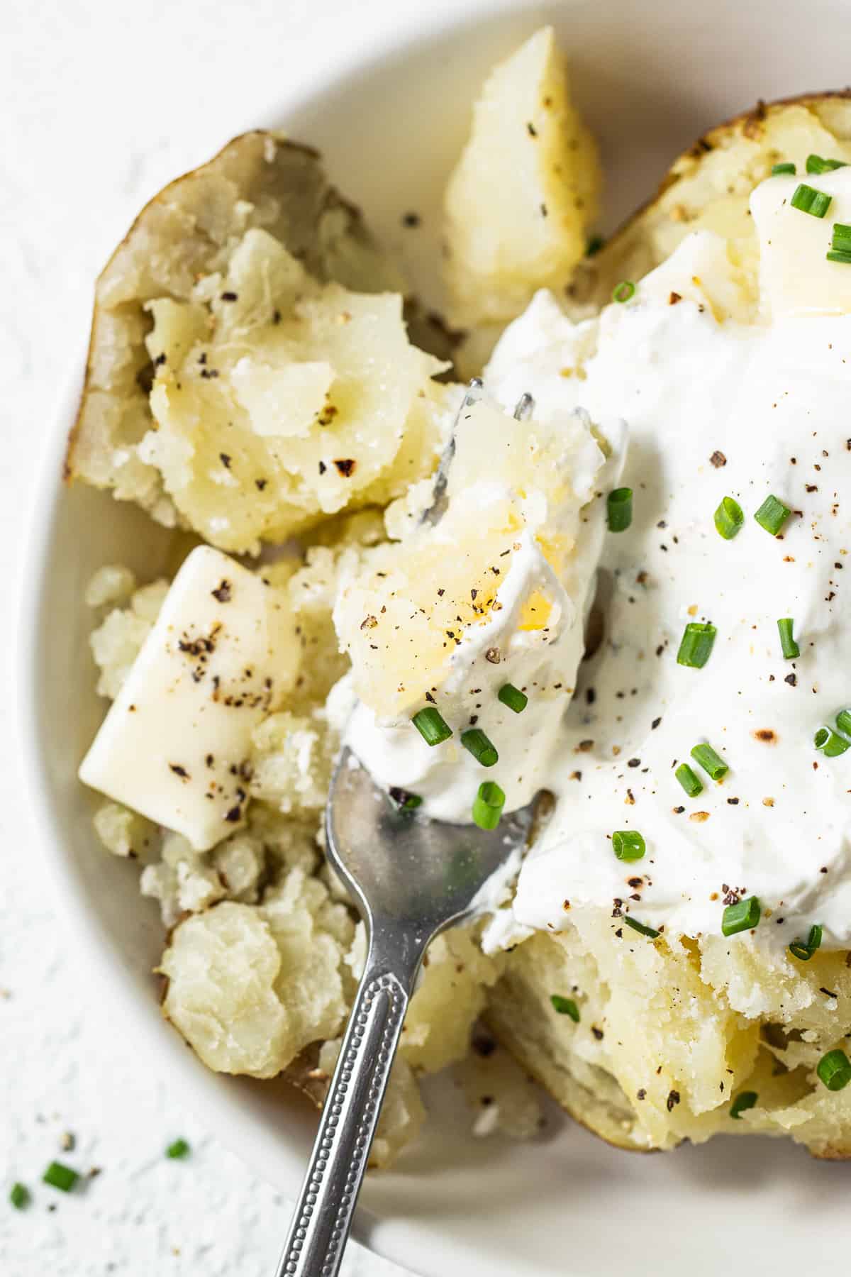 fluffed potato with fork.