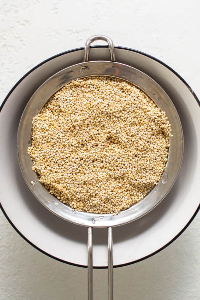 uncooked quinoa in sieve.