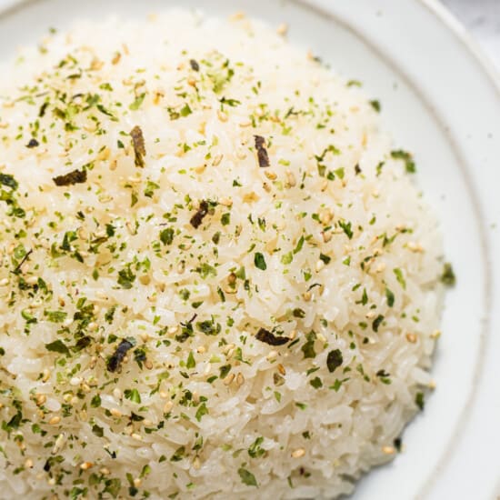 White rice on a plate with herbs and spices.
