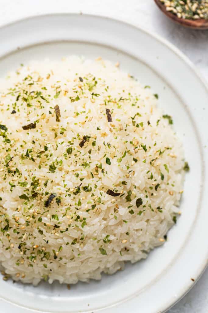 White rice on a plate with herbs and spices.