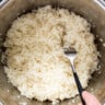 A person pouring rice into an instant pot.