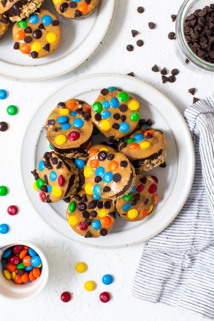 Monster cookie oat cups piled on a plate.