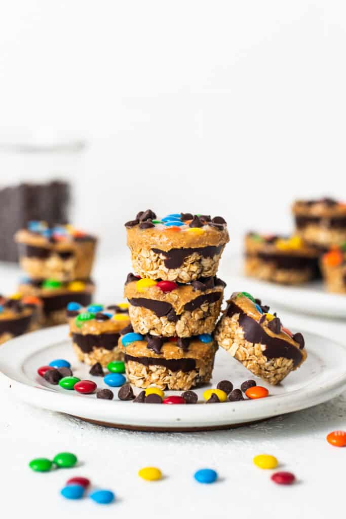 Monster cookie oat cups stacked on a plate.