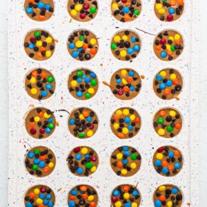 A tray of cookies with m&m's on it.
