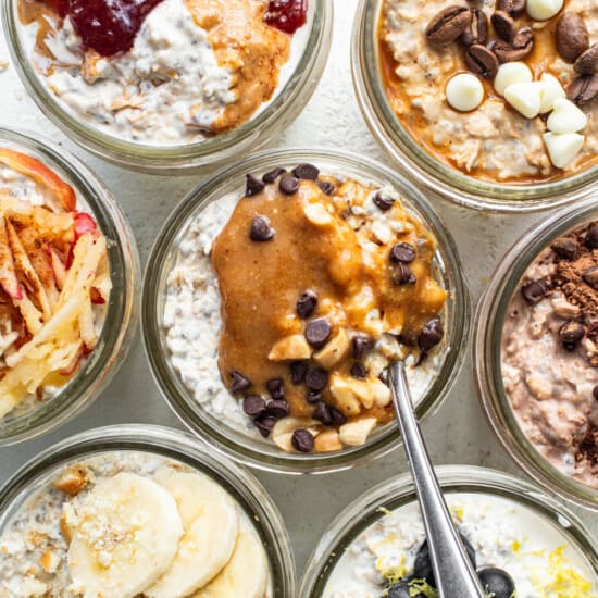 A variety of overnight oats in jars with different toppings.