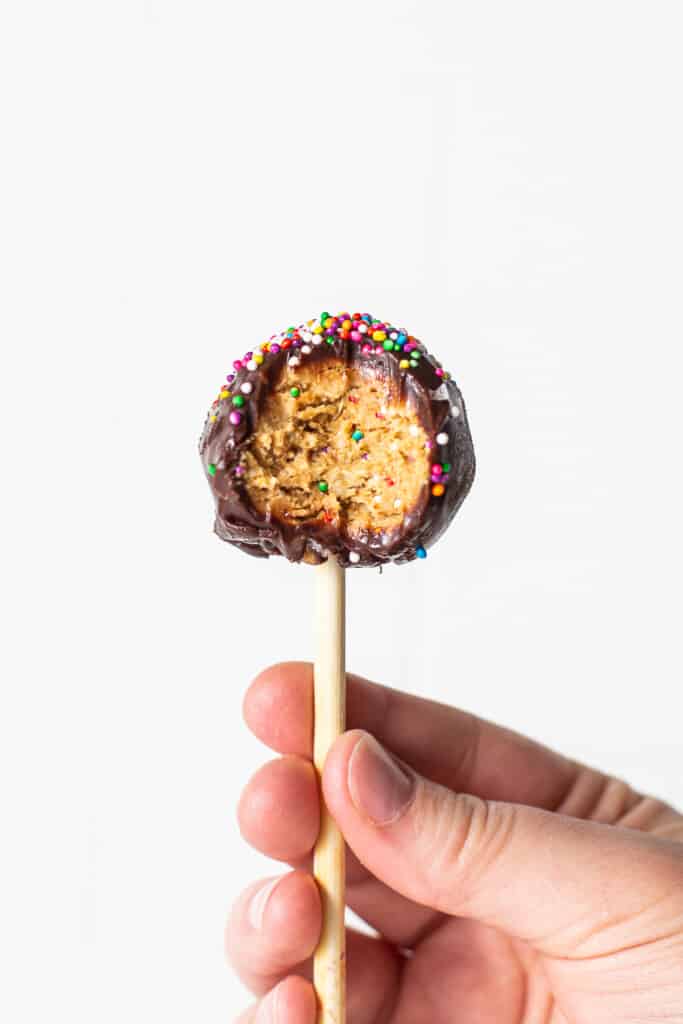 A protein cake pop with a bite out of it.