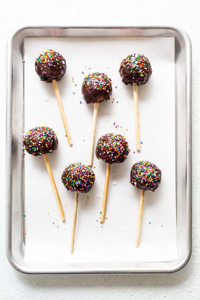 Protein cake pops on a cookie sheet.