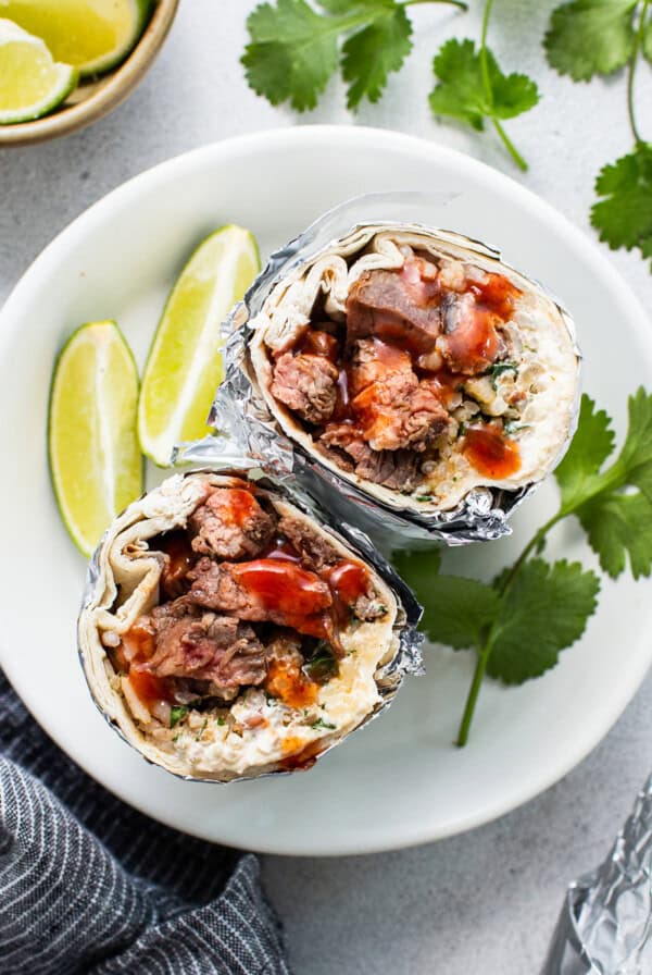 Steak burrito on a plate.