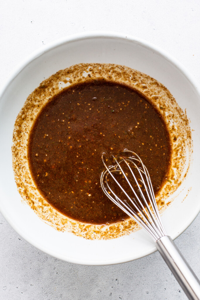 Steak fajita marinade whisked together in a bowl.