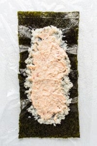 a piece of sushi on a white surface.