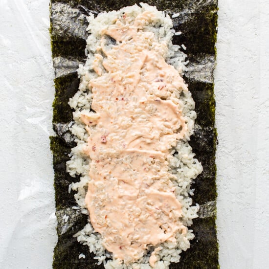 a piece of sushi on a white surface.