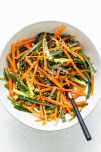 a white bowl filled with carrots and green beans.