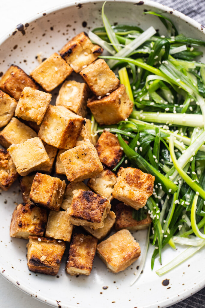 Fried tofu on plate.