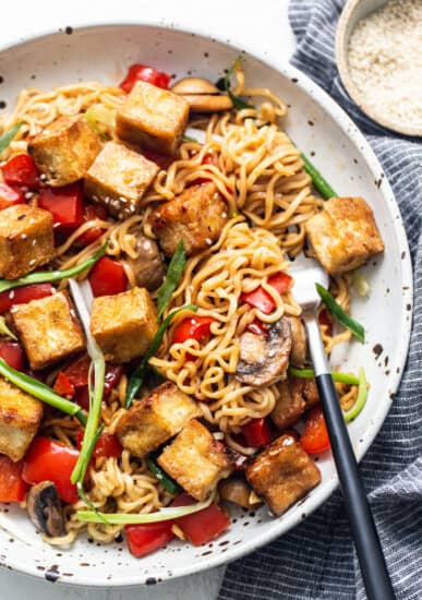 Tofu stir fry in a pan with mushrooms and vegetables.