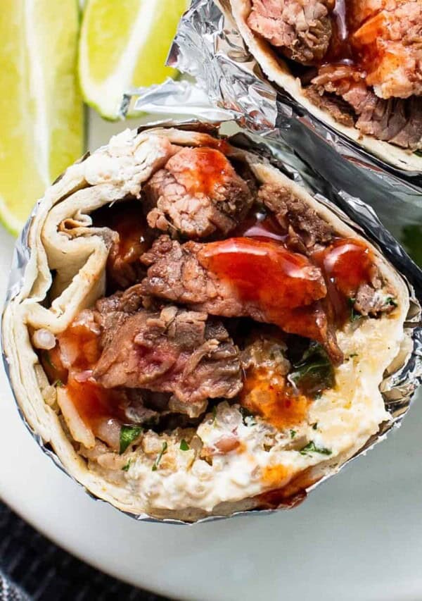 Steak burrito on a plate.