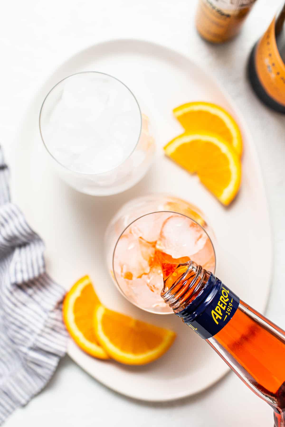 Aperol being poured into a glass.