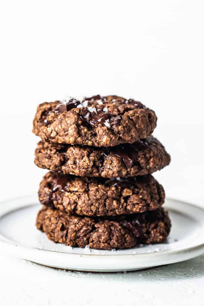 A stack of chocolate oatmeal cookies on a plate.