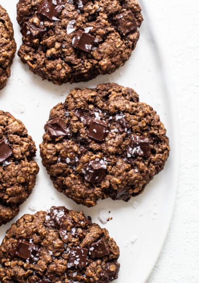 Chocolate oatmeal cookies on a white plate.