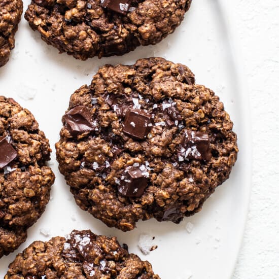Chocolate oatmeal cookies on a white plate.
