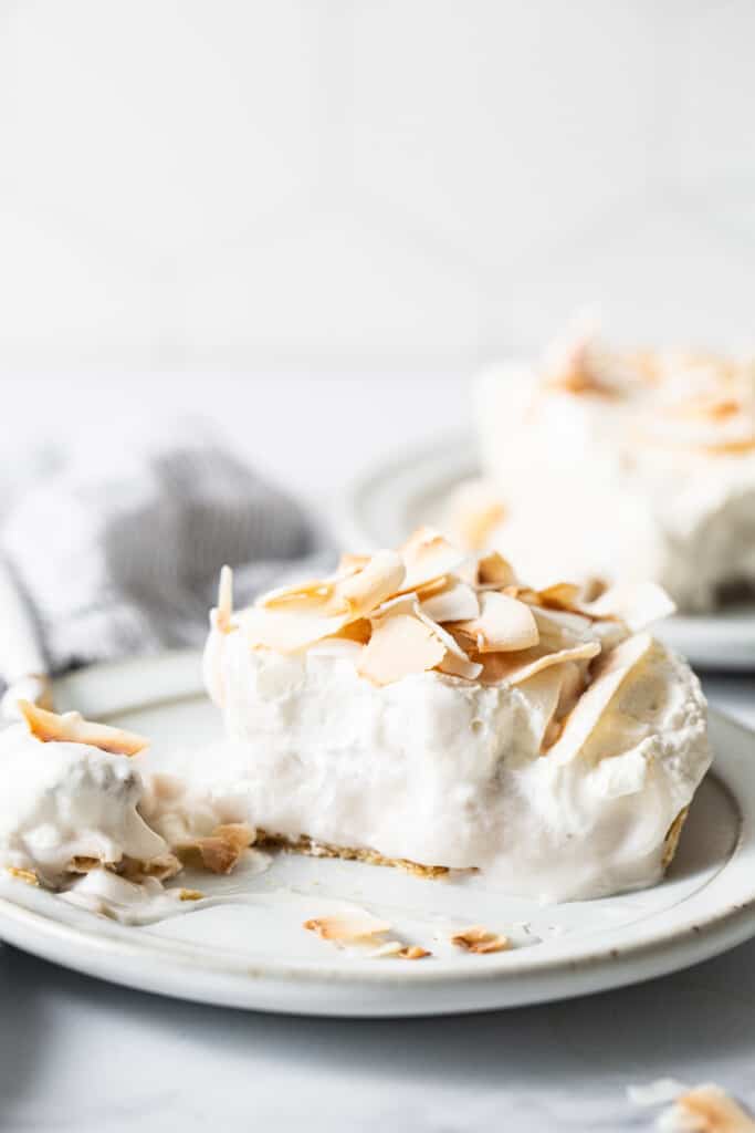 a slice of coconut cream pie on a plate.