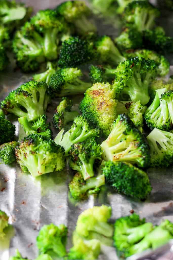 a bunch of broccoli sitting on top of a sheet of foil.