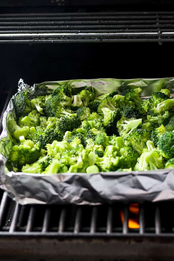 a tray of broccoli is cooking in an oven.