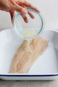 Marinade being poured over fish.