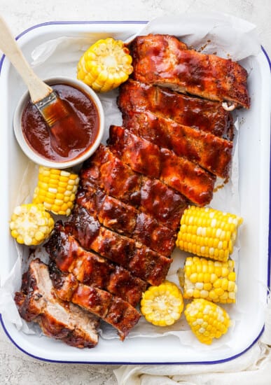 Grilled rack of ribs with corn on the cob.
