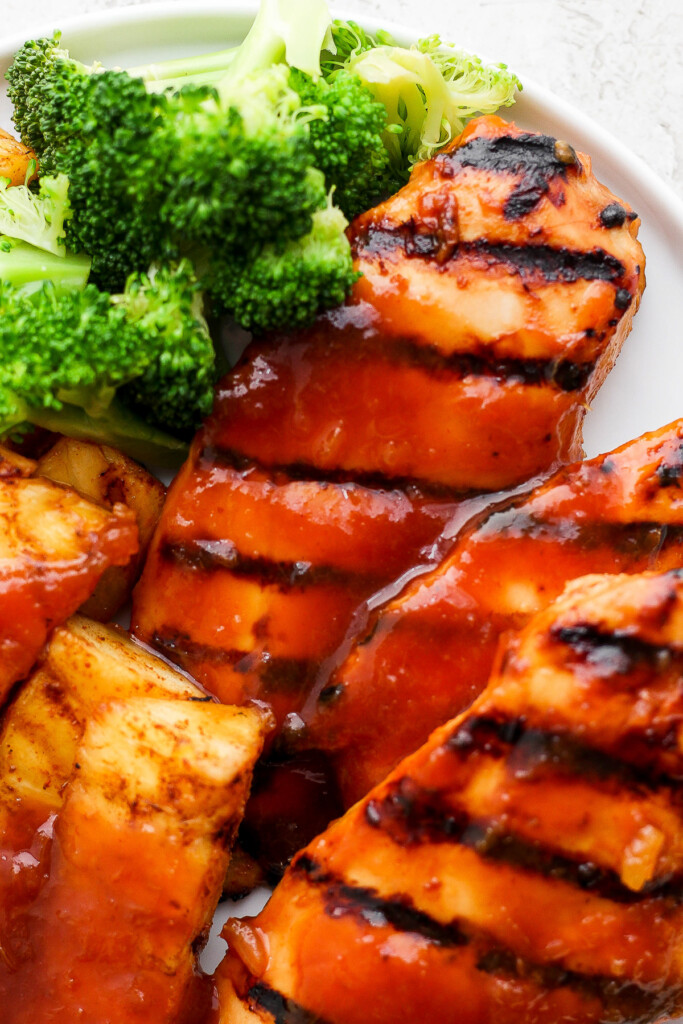 a white plate topped with chicken and broccoli.