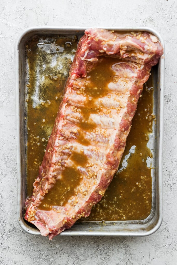 Rack of baby back ribs in a rib marinade.