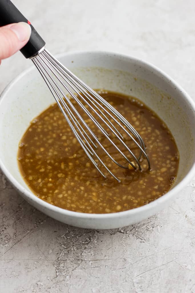 Rib marinade in a bowl with a whisk.