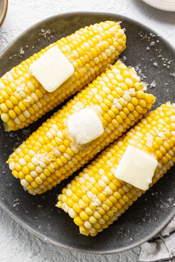 corn on the cob on a plate.