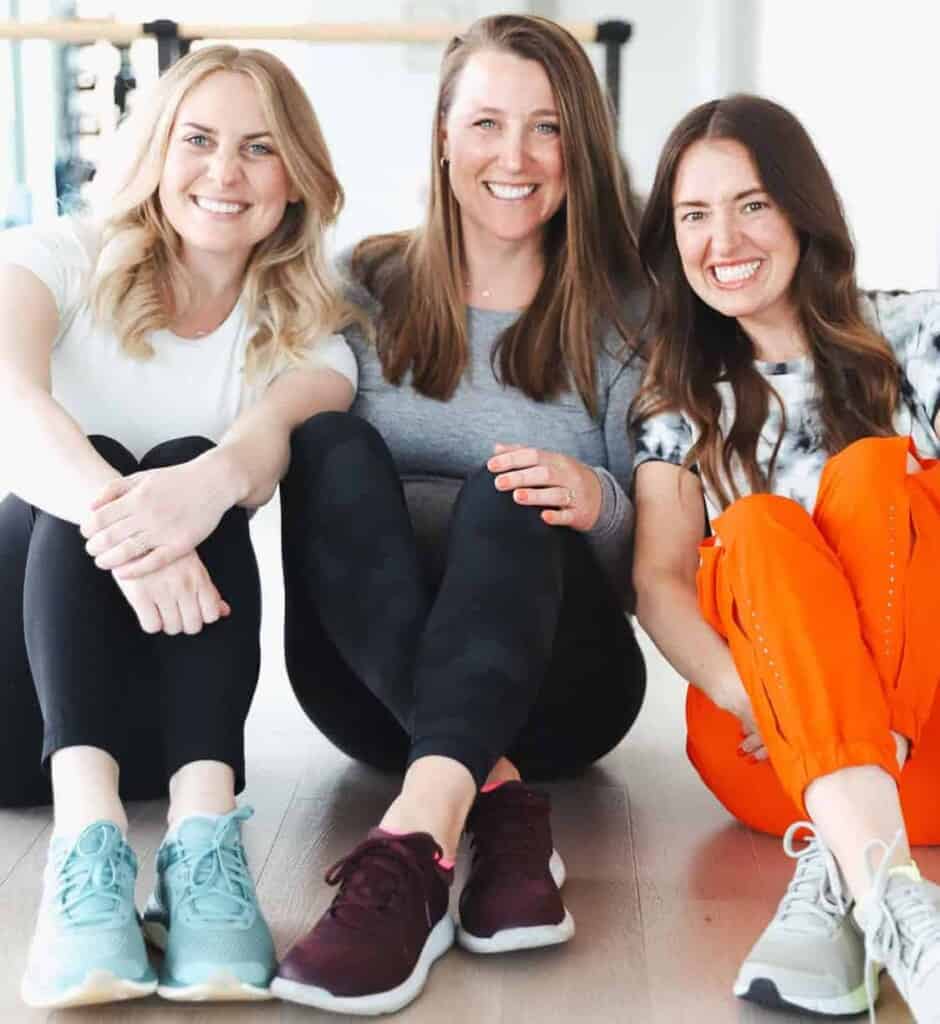 Three women sitting connected  the level  wearing lululemon shoes.